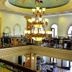 The Grand Palace Hotel Malang restaurant interior with ornate chandelier and balcony railing