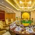 Dongguan Huaxi International Hotel in Dongguan banquet room with a large round dining table and gold decor