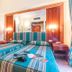 Raeli Hotel Lazio Rome twin bed room with striped bedding, wooden doors, mirror and bedside lamps
