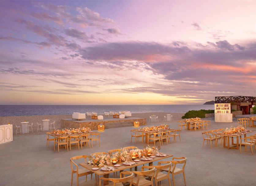 Dreams Los Cabos Suites Golf Resort & Spa terrace dining with ocean sunset views in Cabo San Lucas