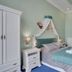 Aphrodite Hotel Marianske Lazne bedroom with canopy bed, wardrobe and blue carpet in Mariánské Lázně