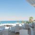 Vrissiana Boutique Beach Hotel in Protaras: seaside terrace with white chairs overlooking the sea