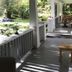 Mountain Meadows Inn & Chalet Suites in Ashford porch with wooden chairs and view of the green garden