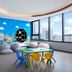 Somerset Rama 9 Bangkok kids' playroom with teepee, colorful table and chairs, mural wall, and city view