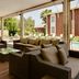 Protea Hotel by Marriott Bloemfontein poolside patio with wicker seating and outdoor pool view