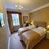 The Upper House in Stoke-on-Trent guest room with two twin beds, window and chandelier