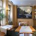 Galerie Hotel Leipziger Hof in Leipzig: cozy hotel bar with tables, stools, and display cabinet