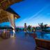 Konokono Beach Resort and Isaraya Over Water Villa in Michamvi: thatched poolside cabana at sunset