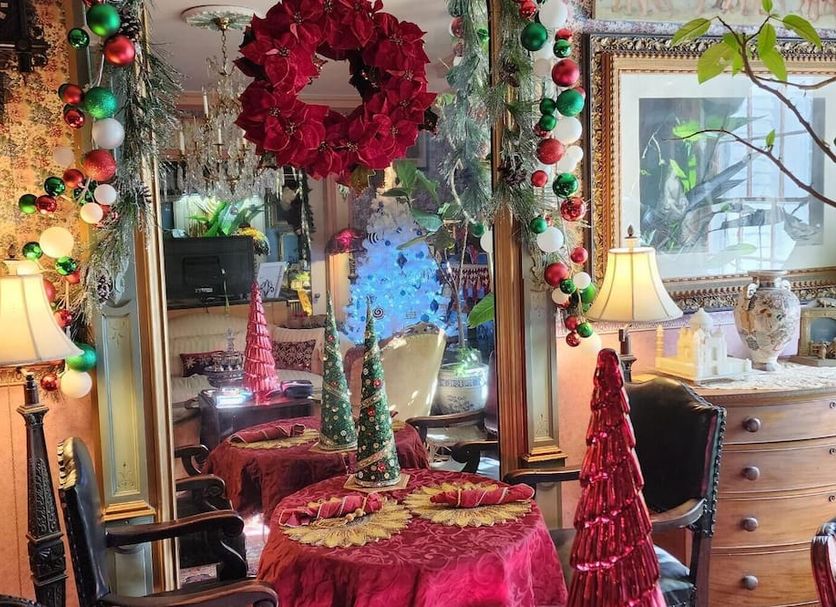 House of 1833 Bed and Breakfast in Mystic, festive holiday-decorated parlor with mirror and lamps