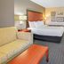 La Quinta Inn & Suites By Wyndham Dfw Airport South / Irving guest room with king bed and sitting area