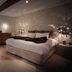 Petit Hôtel Confidentiel in Chambéry: stylish bedroom with freestanding tub, exposed brick wall, and king bed