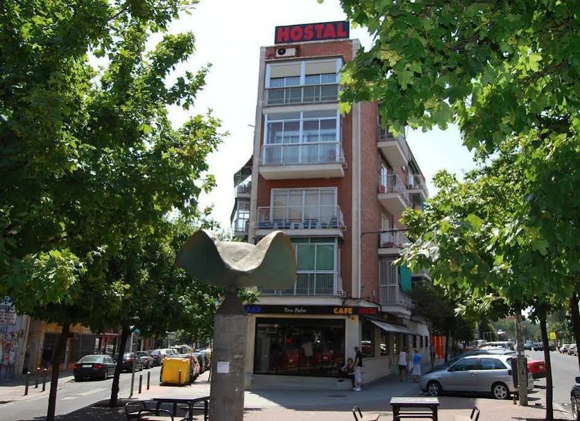 Hostal Don Pedro in Madrid, street view of a multi-story hostal with trees framing the entrance