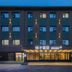 Orange Hotel Beijing Japan Medical University in Beijing exterior at dusk with lit entrance and windows