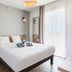 Appart'City Confort Perpignan Centre Gare bedroom with double bed, bedside table and balcony door