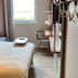 ibis budget Beauvais Aeroport in Tillé guest room with bed, chair, desk, and window