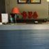 Hotel Restaurant du Lac Agen reception desk with red wall art and dining area in Boé
