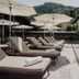 Hotel Berghof - St Johann in Salzburg sun loungers by an outdoor pool with mountain views in Sankt Johann im Pongau
