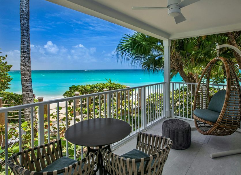Buoy Haus Beach Resort St. Thomas, Autograph Collection balcony with hanging chair and ocean view