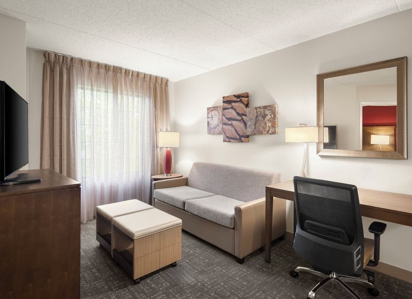 Staybridge Suites Indianapolis-Airport by IHG guest suite with sofa, desk, and window seating in Plainfield