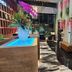 The Park Residence Bangkok lobby with glowing planter, marble floor, and tufted benches