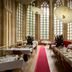 Kruisherenhotel Maastricht dining room with red carpet, arched windows and elegant restaurant tables