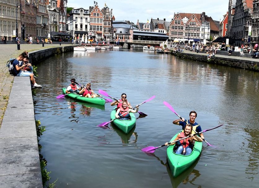 Hostel Uppelink in Ghent with canal kayakers and historic riverside buildings