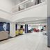 Holiday Inn Express & Suites Pekin lobby with fireplace, TV seating area, and open mezzanine