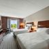 Hilton Garden Inn Winchester guest room with two beds and a window view of trees