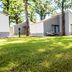 Forest Village Resort in Medjugorje with white bungalow-style guest rooms and grassy grounds among trees