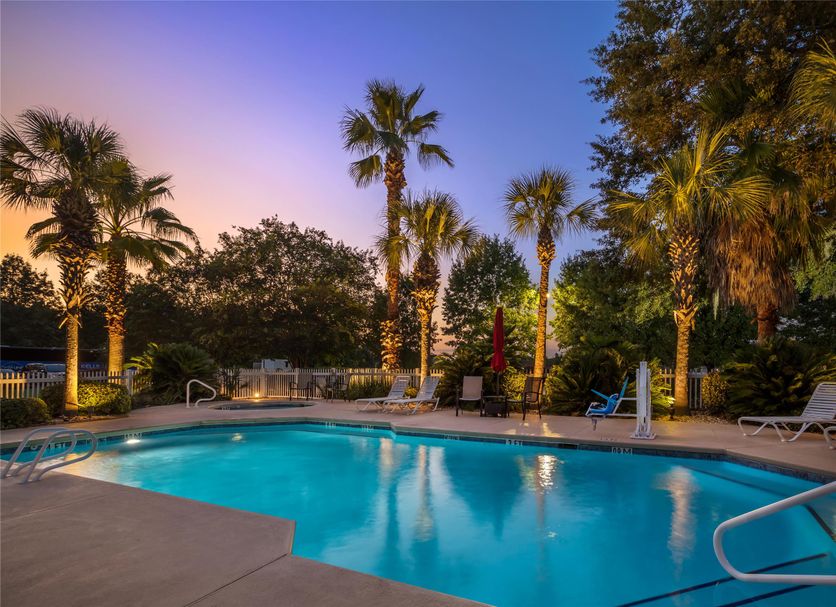 Best Western Plus Valdosta Hotel & Suites pool at dusk with palm trees and lounge chairs in Valdosta