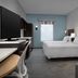 Home2 Suites by Hilton Lake City guest room with two beds, TV, sofa and window wall
