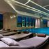 Sheraton Nanchang Hotel indoor pool with lounge chairs and city views in Nanchang