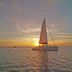 Margaritaville Beach Resort Grand Cayman in George Town, sunset sailboat on calm ocean