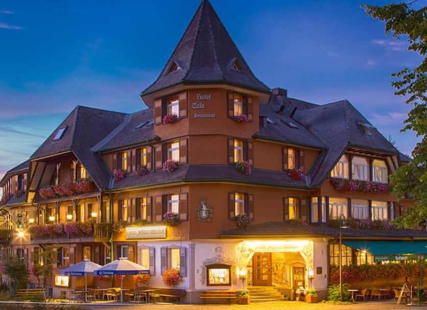 Schwarzwaldhof in Hinterzarten, a chalet-style hotel with lit balconies at dusk