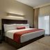 Berlin Grande Hotel room in Berlin with king bed, armchair and large windows with sheer curtains