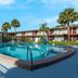Red Roof Inn Vero Beach - I-95 outdoor pool with palm trees and two-story motel rooms in Vero Beach