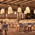 Aqua Blue Beach Hotel, Perissa: elegant outdoor dining area with white tables, chairs and hanging lamps