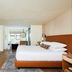The Stavrand Russian River Valley guest room in Guerneville with king bed, TV, and bathroom vanity
