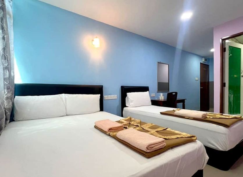 Ark Hotel Subang in Shah Alam: twin beds in a simple blue guest room with folded towels