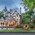 1899 Wright Inn & Carriage House in Asheville, Victorian inn exterior with lit windows and landscaped garden