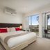 Quest Sanctuary Lakes in Melbourne bedroom with balcony and lake view through open doors