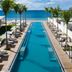 Silversands Grand Anse in St. George's: oceanfront infinity pool with loungers and palm trees
