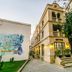 Deniz Inn Boutique Hotel in Baku, a beige historic building with arched windows and a cobblestone entrance