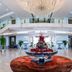 Haiqing Hotel Qingdao grand lobby with chandelier, glass balcony, and floral centerpiece