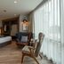 Bella B Hotel in Mueang Nonthaburi guest room with king bed, seating area and floor-to-ceiling window