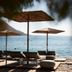 Cayo Exclusive Resort & Spa in Elounda with seaside loungers and straw umbrellas overlooking the water