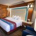 Prairie Band Casino & Resort in Mayetta guest room with king bed, wood accent wall and seating area