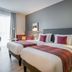 Citadines Arnulfpark Munich guest room with two beds, desk, and bright window in Munich