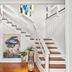 Mar Bella Boutique Hotel & Spa in Rehoboth Beach: bright stair hall with wood steps, art, and decor