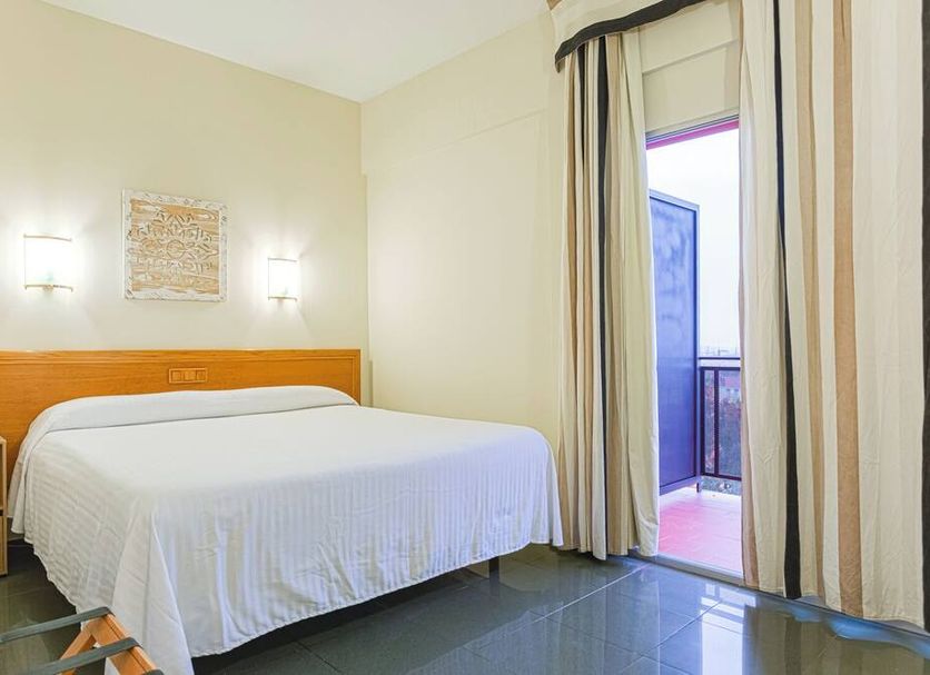 Hotel Zeus Merida guest room with double bed and balcony door